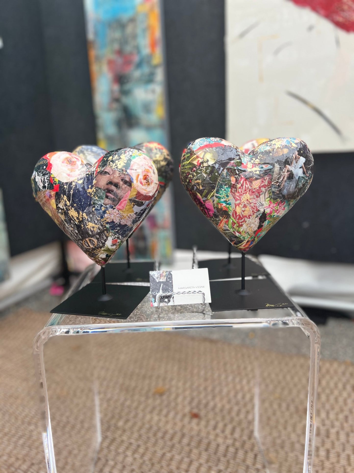 a collection of vibrant small heart sculptures with multicolor collage and gold leaf details, perfect for modern decor