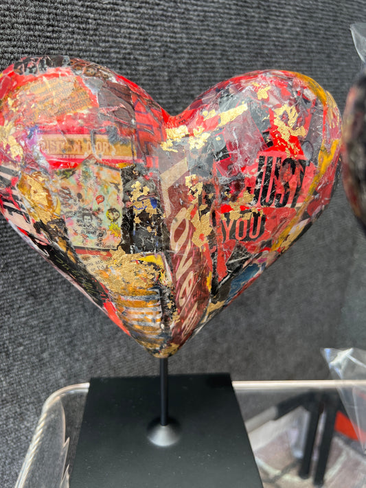 A small sculpture of a colorful mixed media collage heart, a perfect gift for your love ones