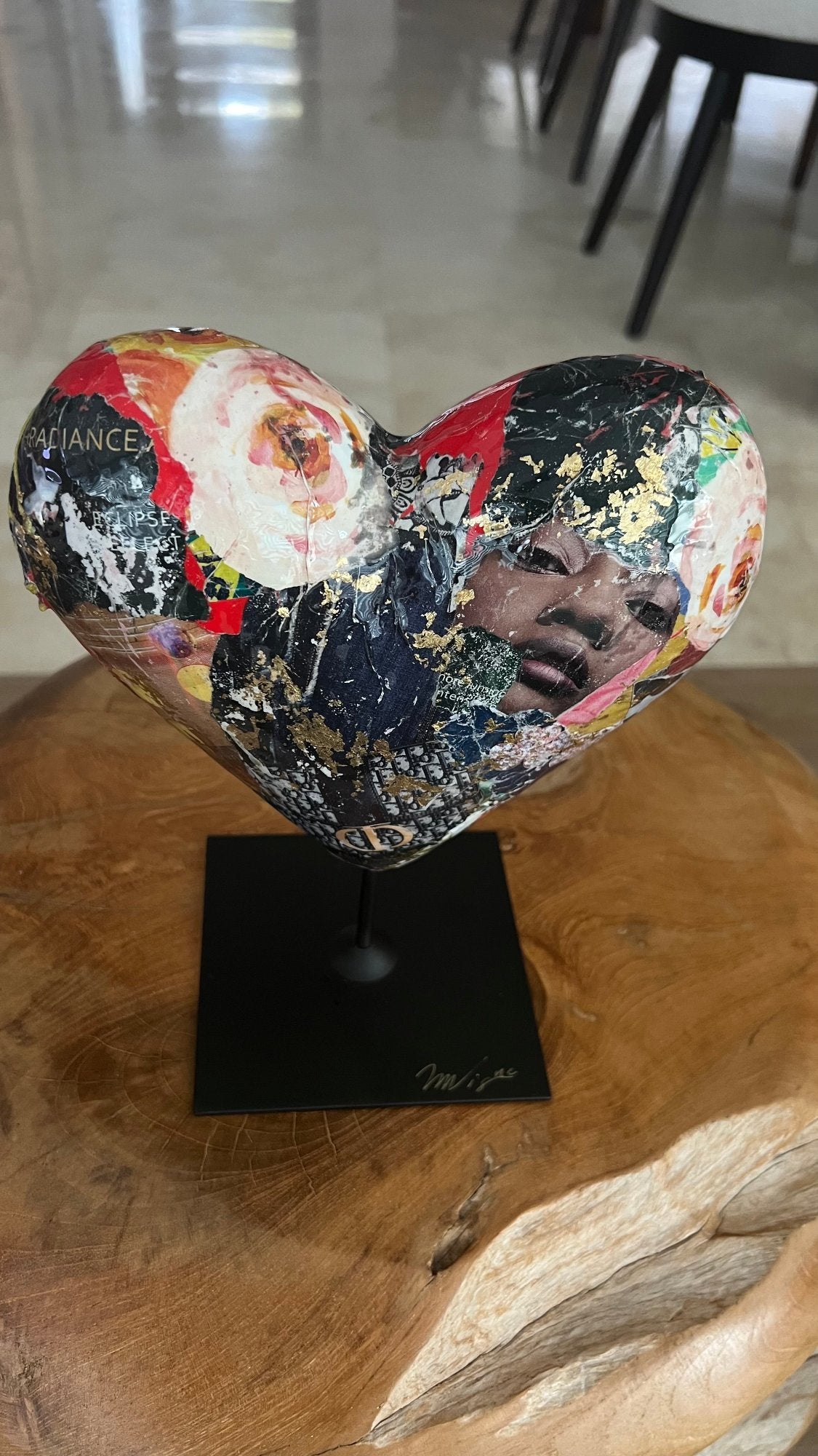 Love-themed heart sculpture with vibrant abstract elements and floral patterns